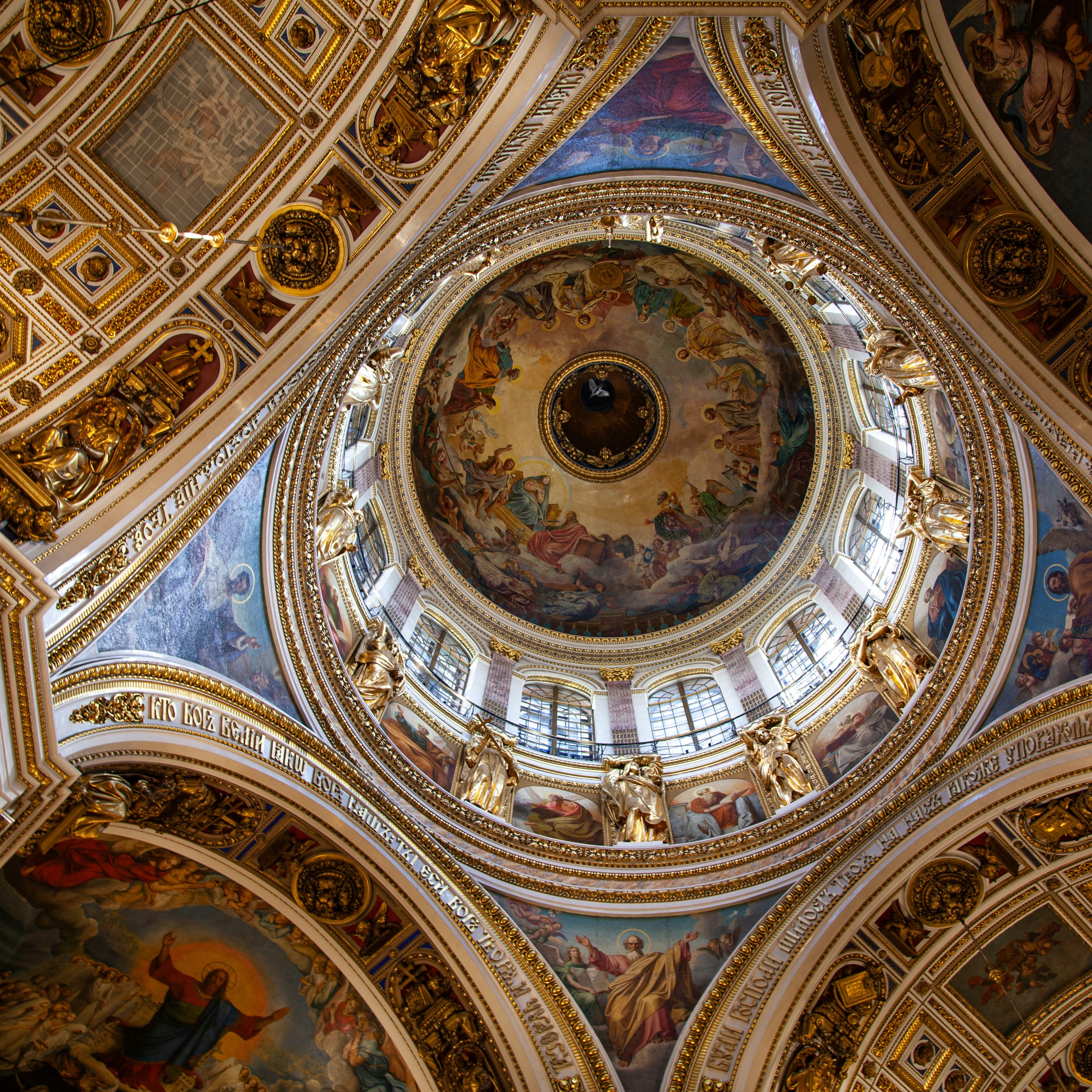 Ceiling of a large building with classical art.