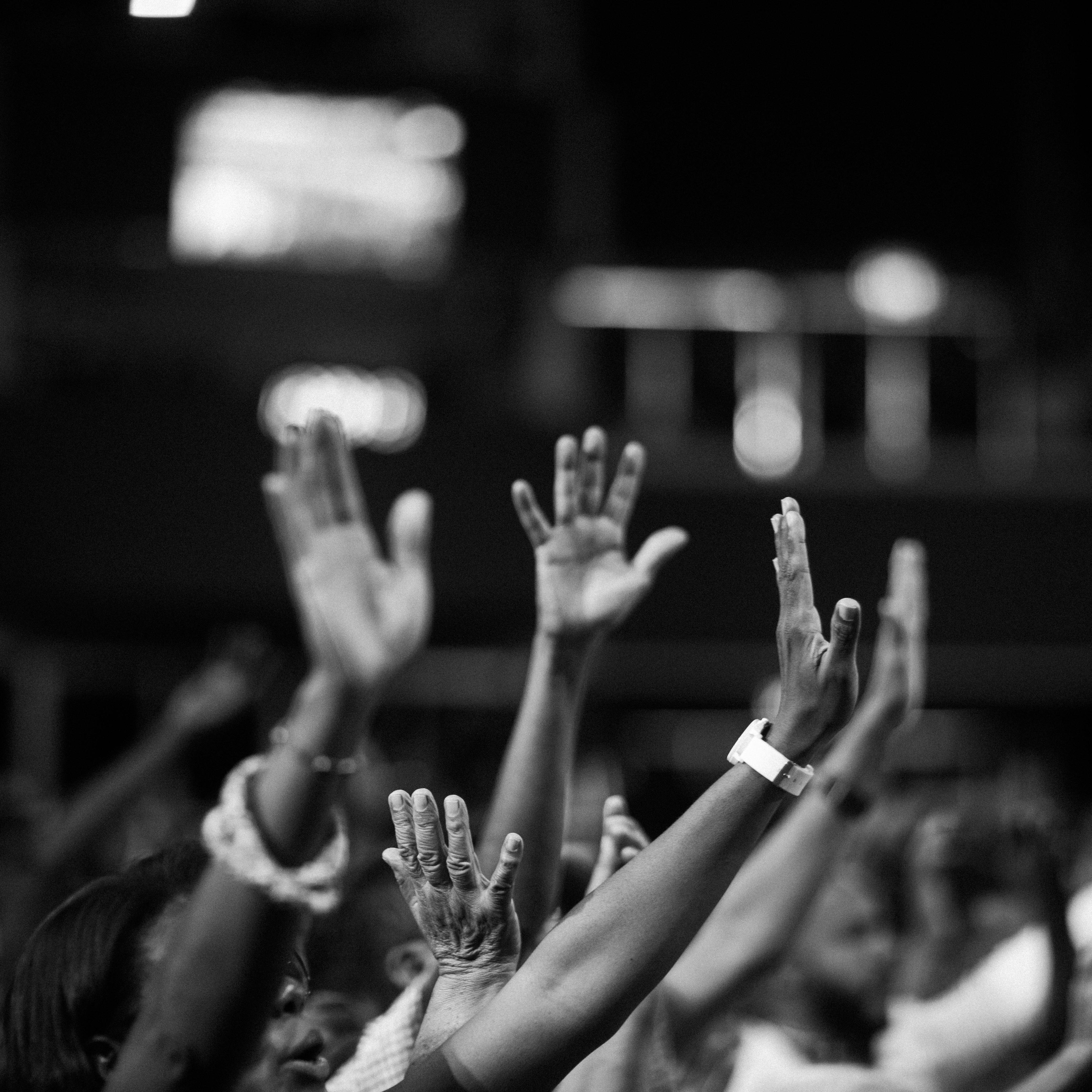 Crowd raising their hands at a party.