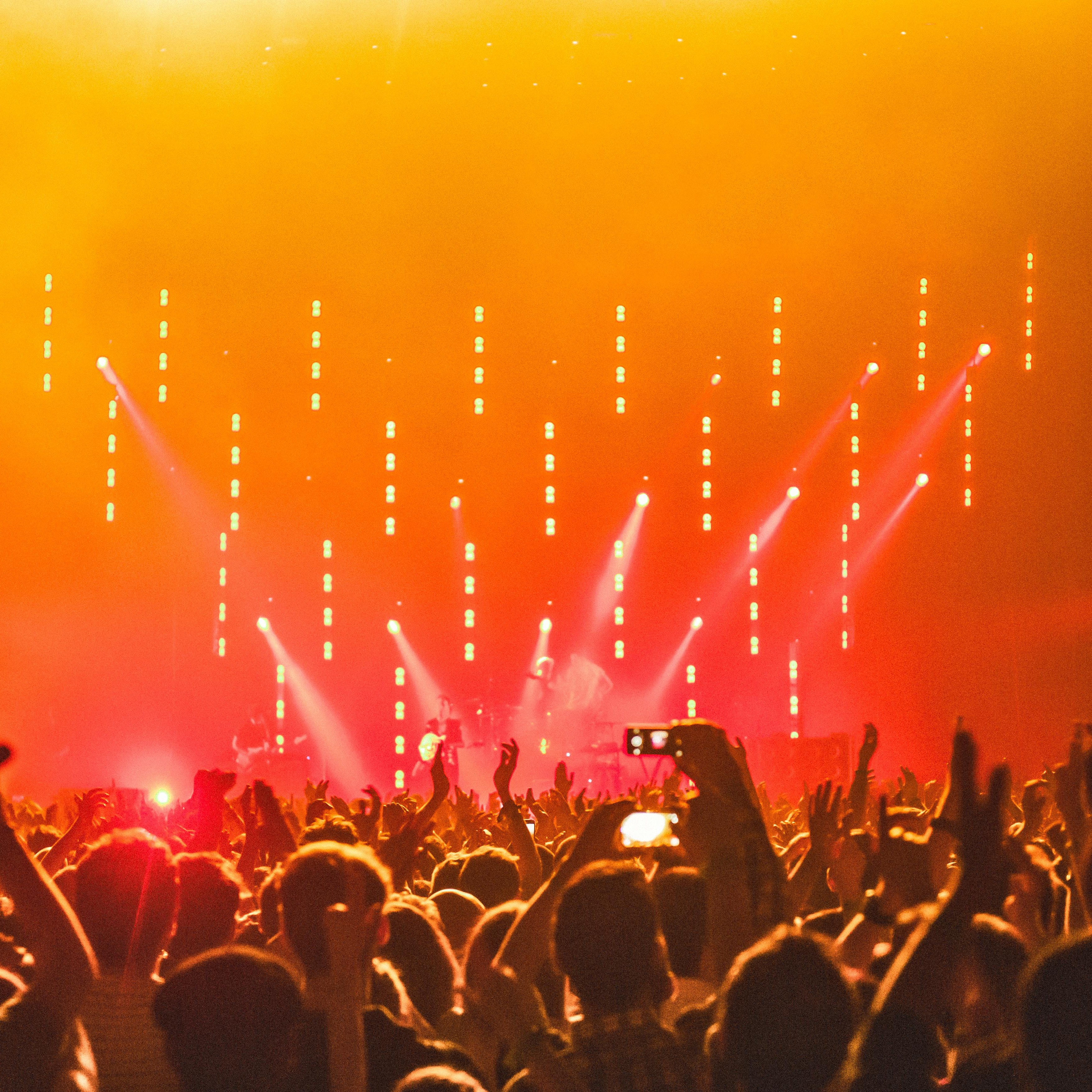 Pop music performance with colorful lights and stage energy.