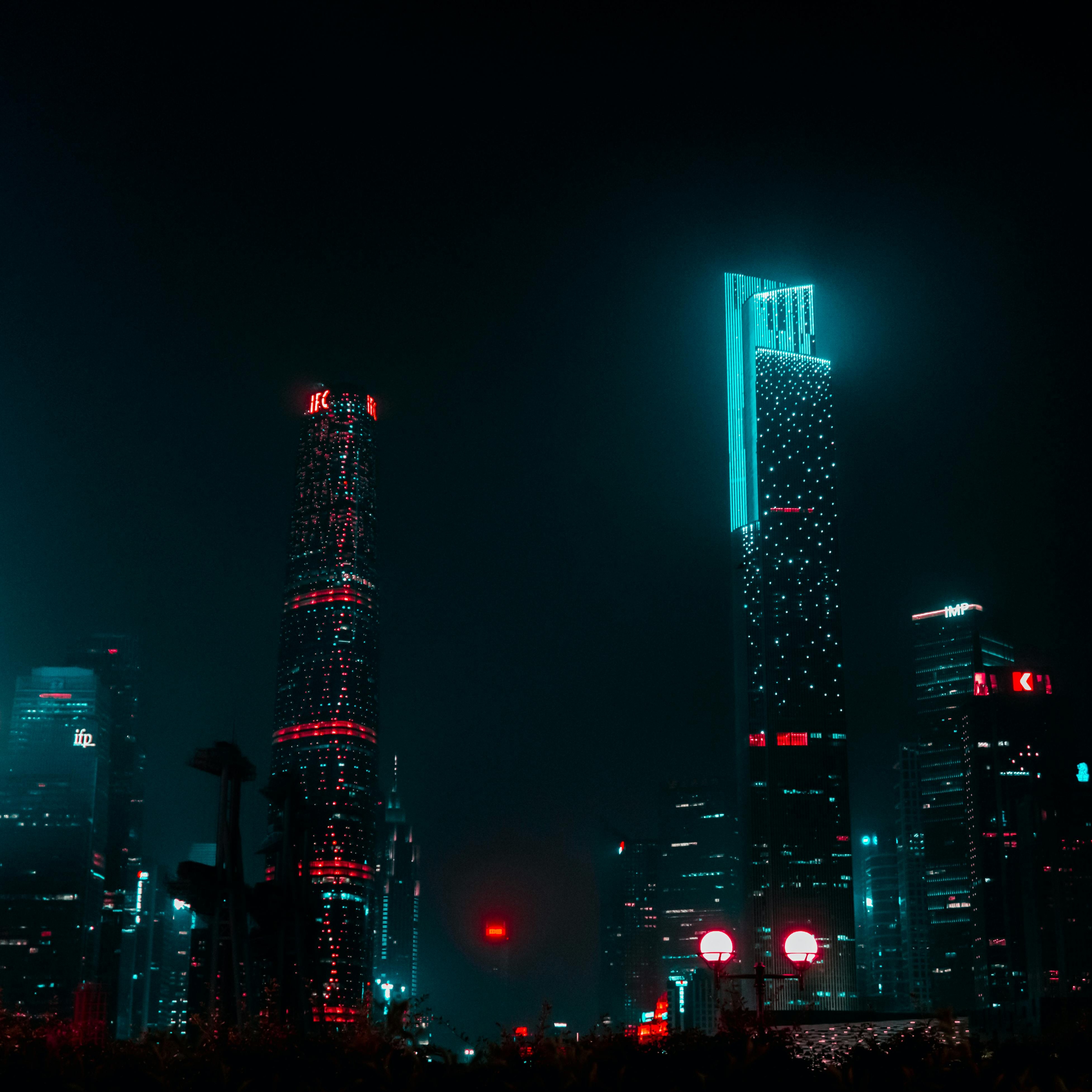 Futuristic city at night with lights.